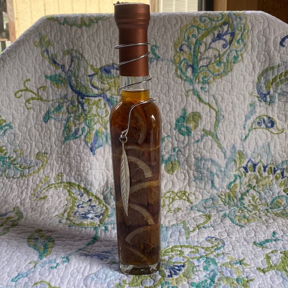 Bottle of preserved oranges in oil.
